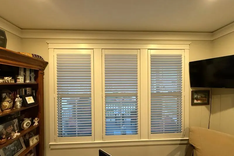 White plantation shutters on three home office windows, installed by our team