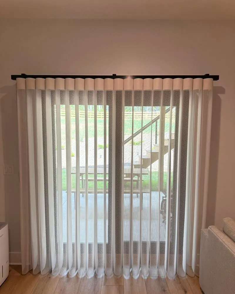 SmartDrape vanes drawn across a patio door with the yard visible through them